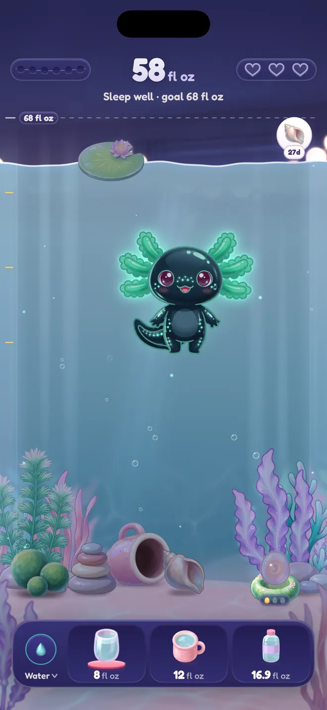 The tank at night with a glowing dark axolotl